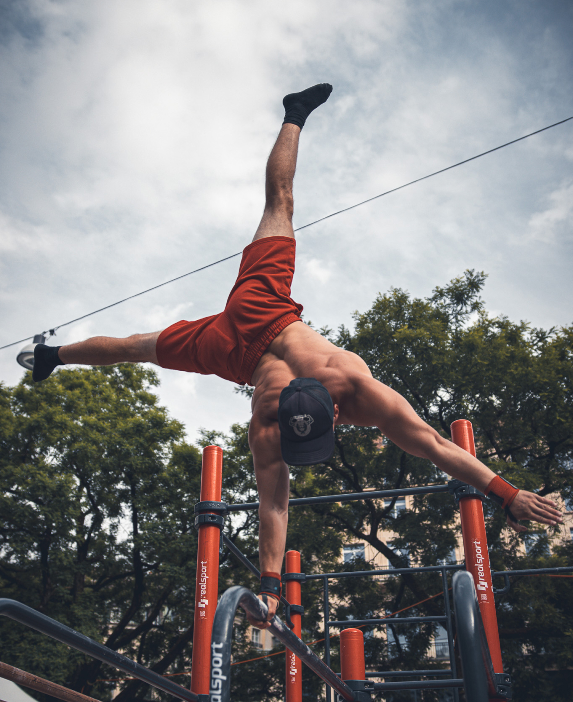 Dominik klimek performing one arm handstand.